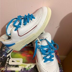 Jordan Kids White Sneakers with Bright Blue Laces and Red Accent